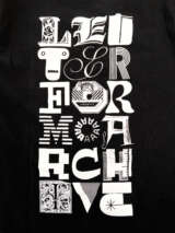 Photo of black t-shirt back with the words “LETTERFORM ARCHIVE” in three columns of letters from various sources.