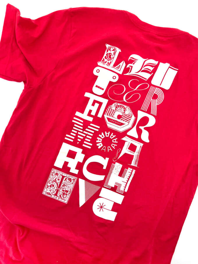 Photo of red t-shirt back with the words “LETTERFORM ARCHIVE” in three columns of letters from various sources.